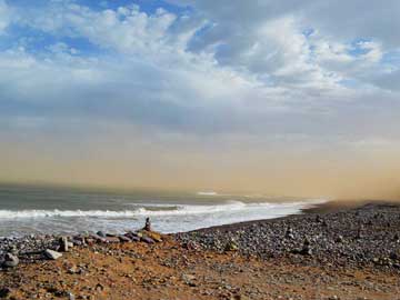 Morocco: Desert storm delivering red sand from the Sahara, Craima Beach, March 2014, Sidi Ifni, Morocco.